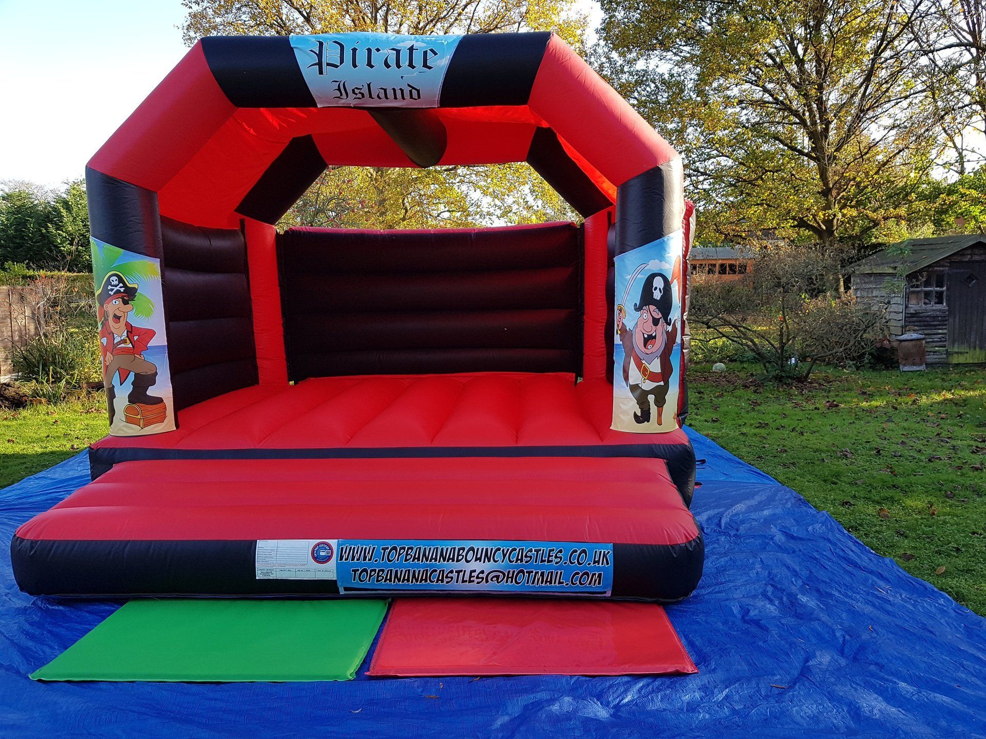 adult red and black bouncy castle with pirate theme