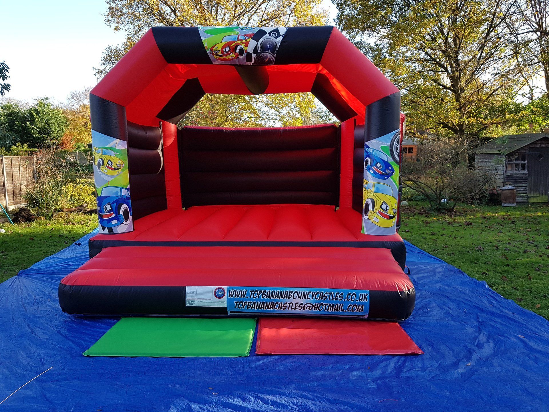 adult red and black bouncy castle with race car theme
