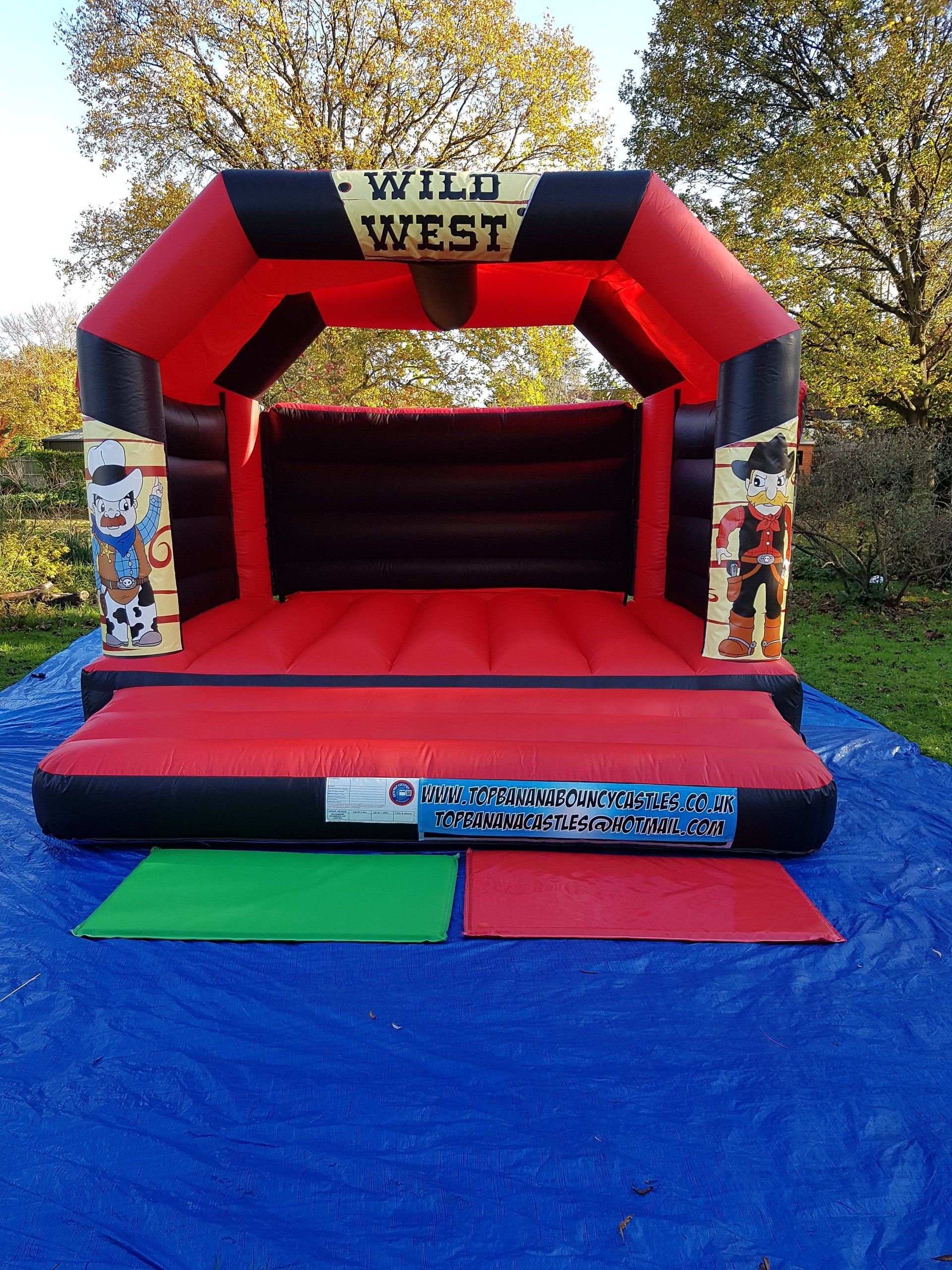 adult red and black bouncy castle with cowboy theme