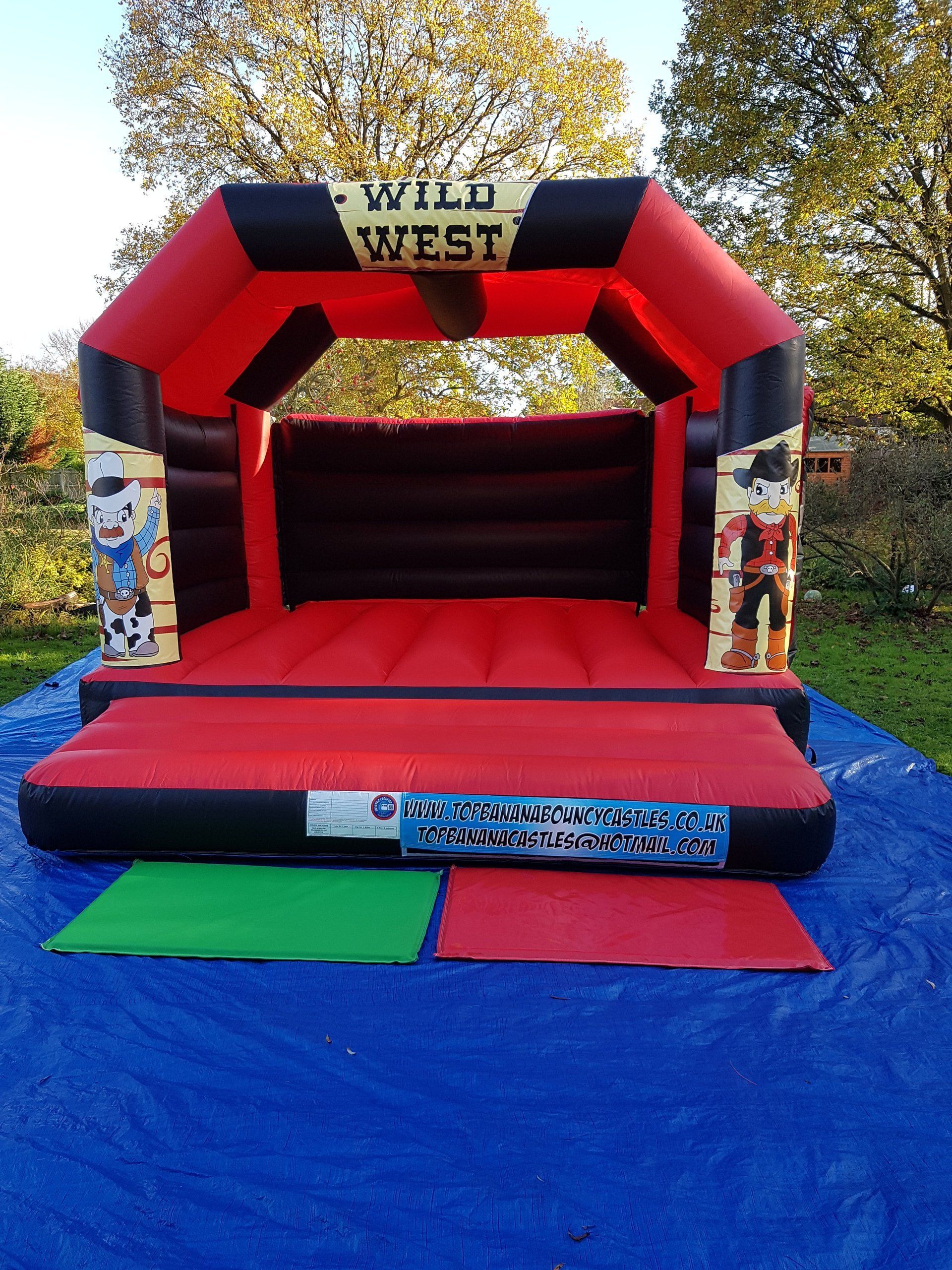 red and black adult bouncy castle with wild west artwork