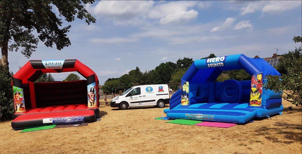 Pirate Island and Hero Bouncer bouncy castles with Top Banana company van
