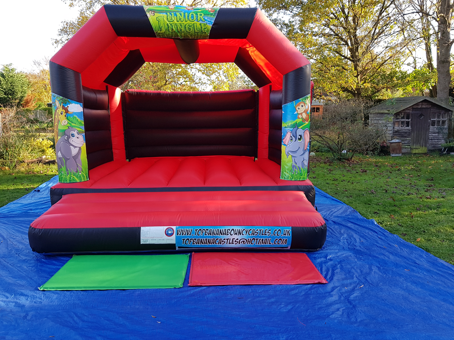 red and black adult bouncy castle with jungle artwork