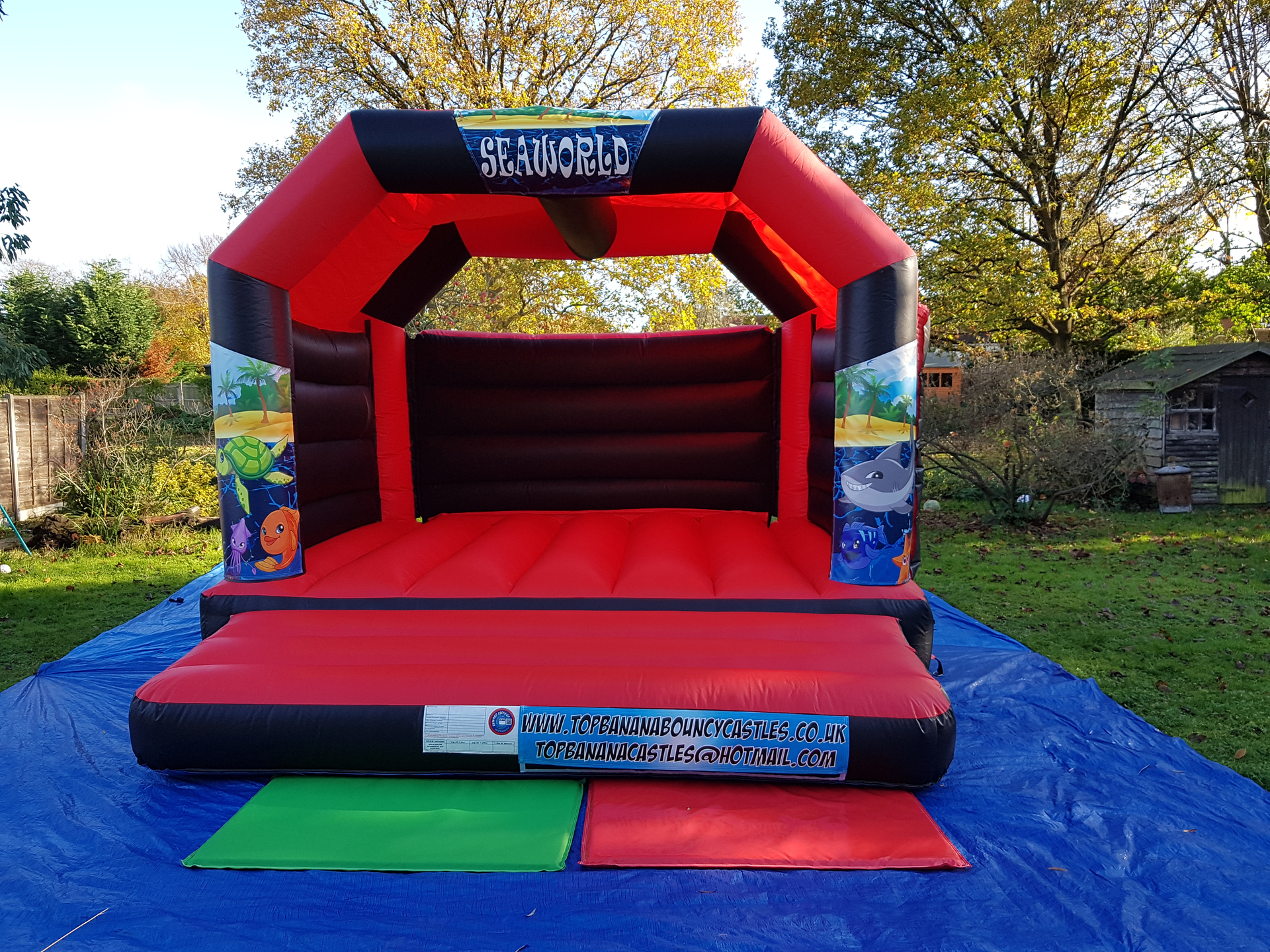 adult red and black bouncy castle with seaworld theme