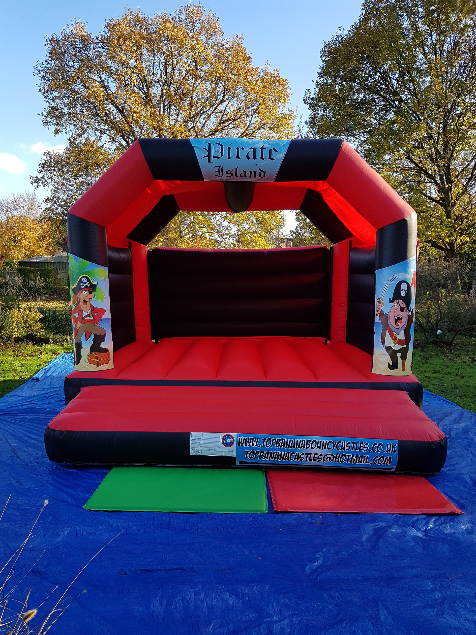 red and black adult bouncy castle with pirate artwork