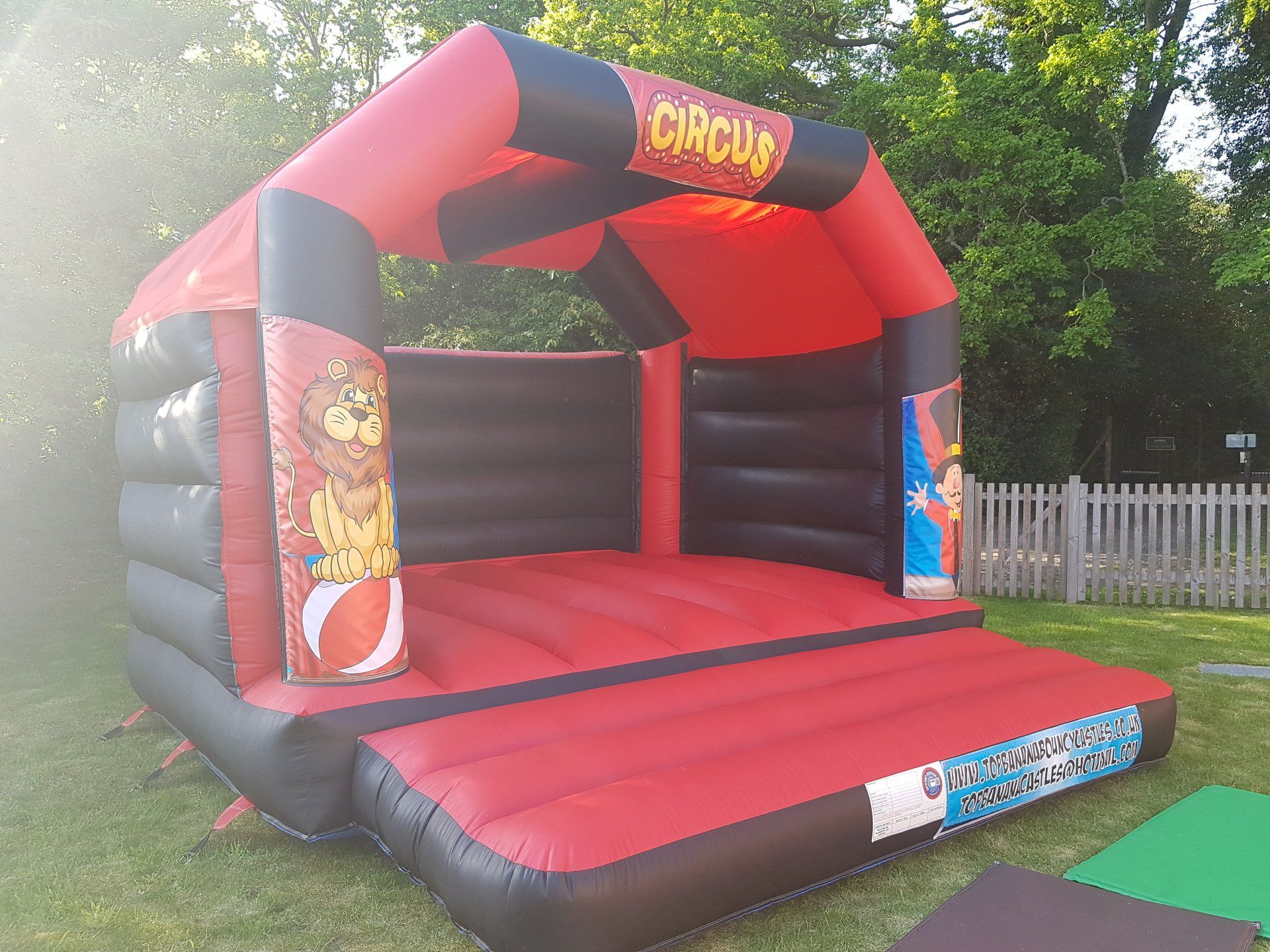 adult red and black bouncy castle with circus theme