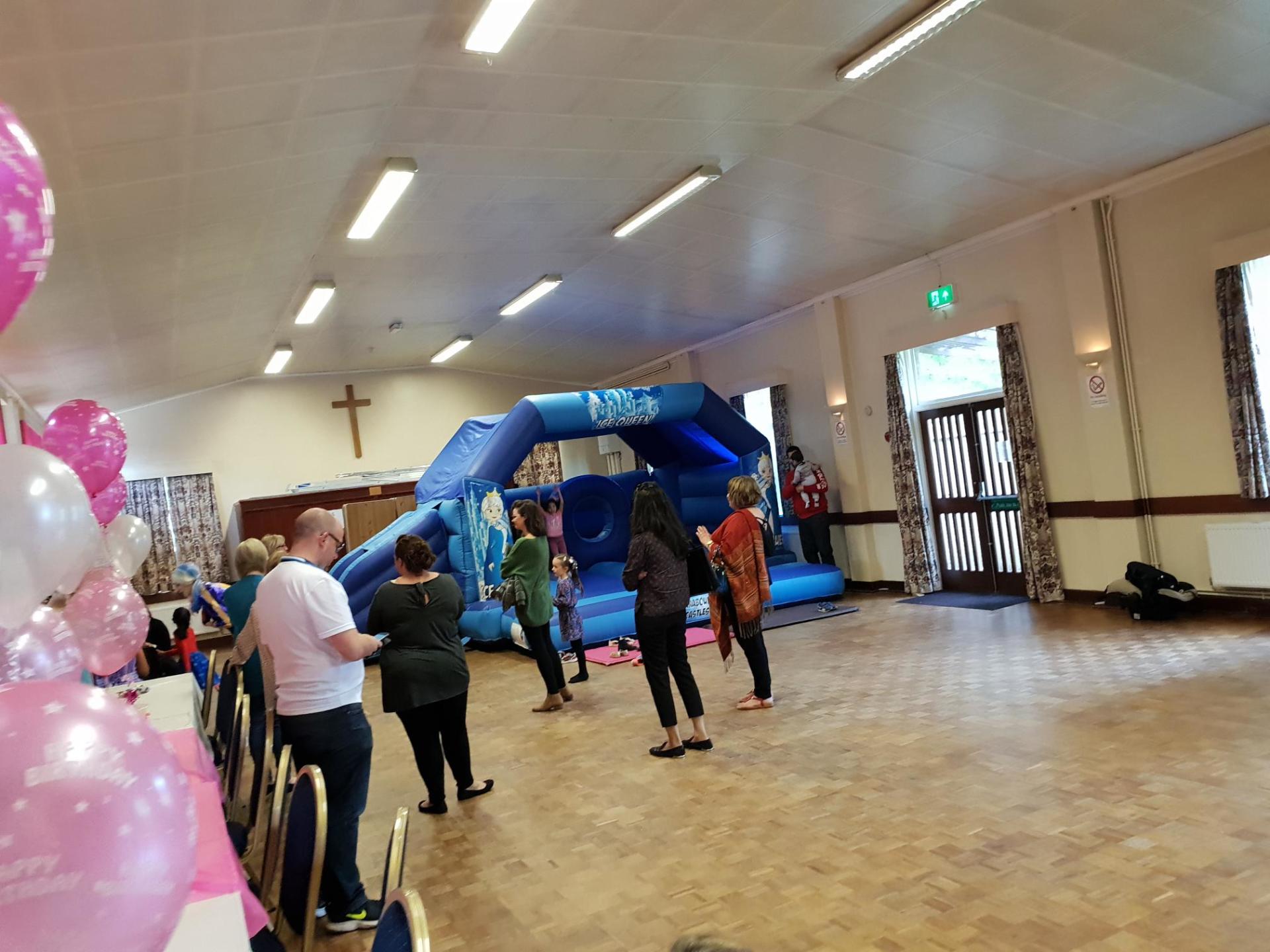 snow queen themed slide combo bouncy castle in village hall