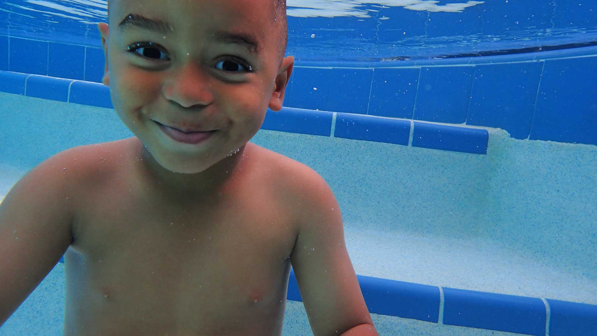Kid Smiling Under Water — Royal Palm Beach, FL — TPowers Swimming