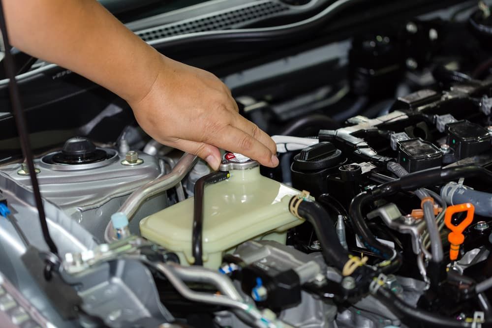 A Person Is Working on The Engine of A Car — Palmerston Auto Clinic in Yarrawonga, NT