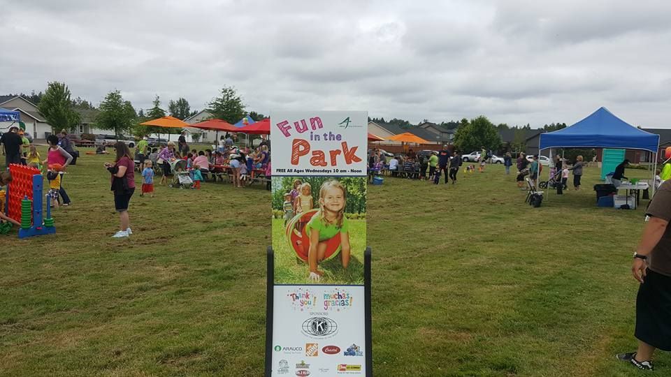 A sign that says fun in the park is in the middle of a grassy field.