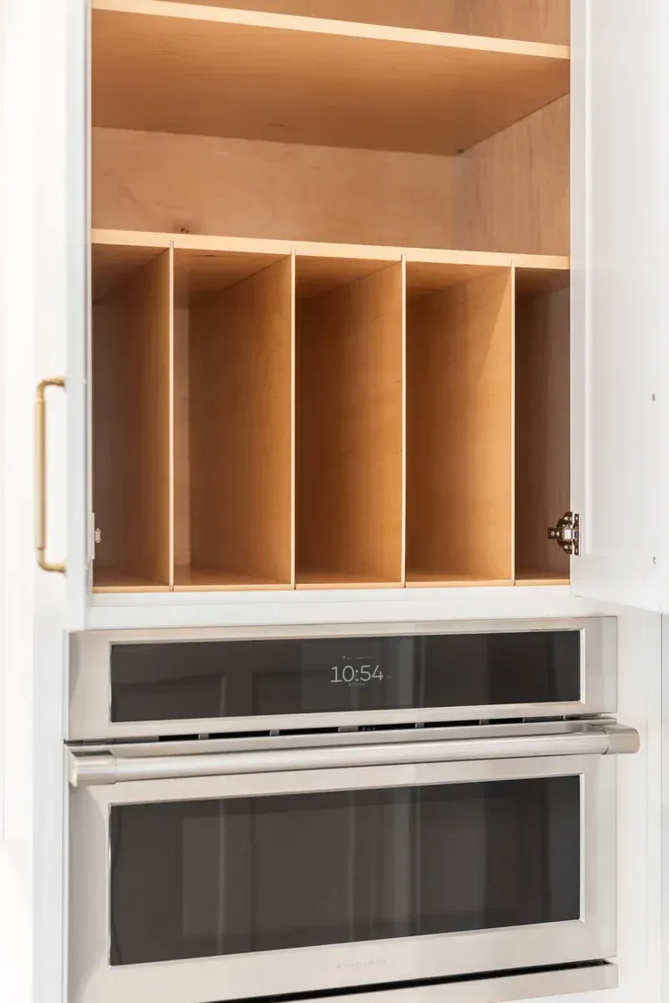 Built-in wooden cabinet with shelves and a stainless steel oven below