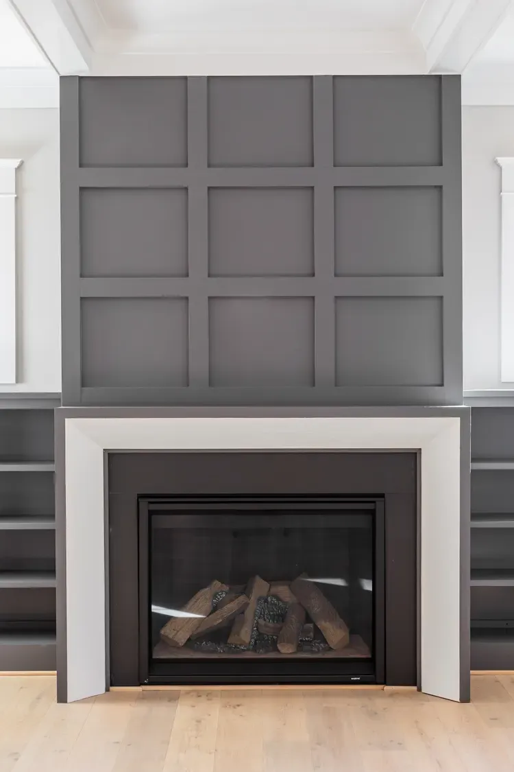 Gray paneled wall above a modern fireplace in a bright living room