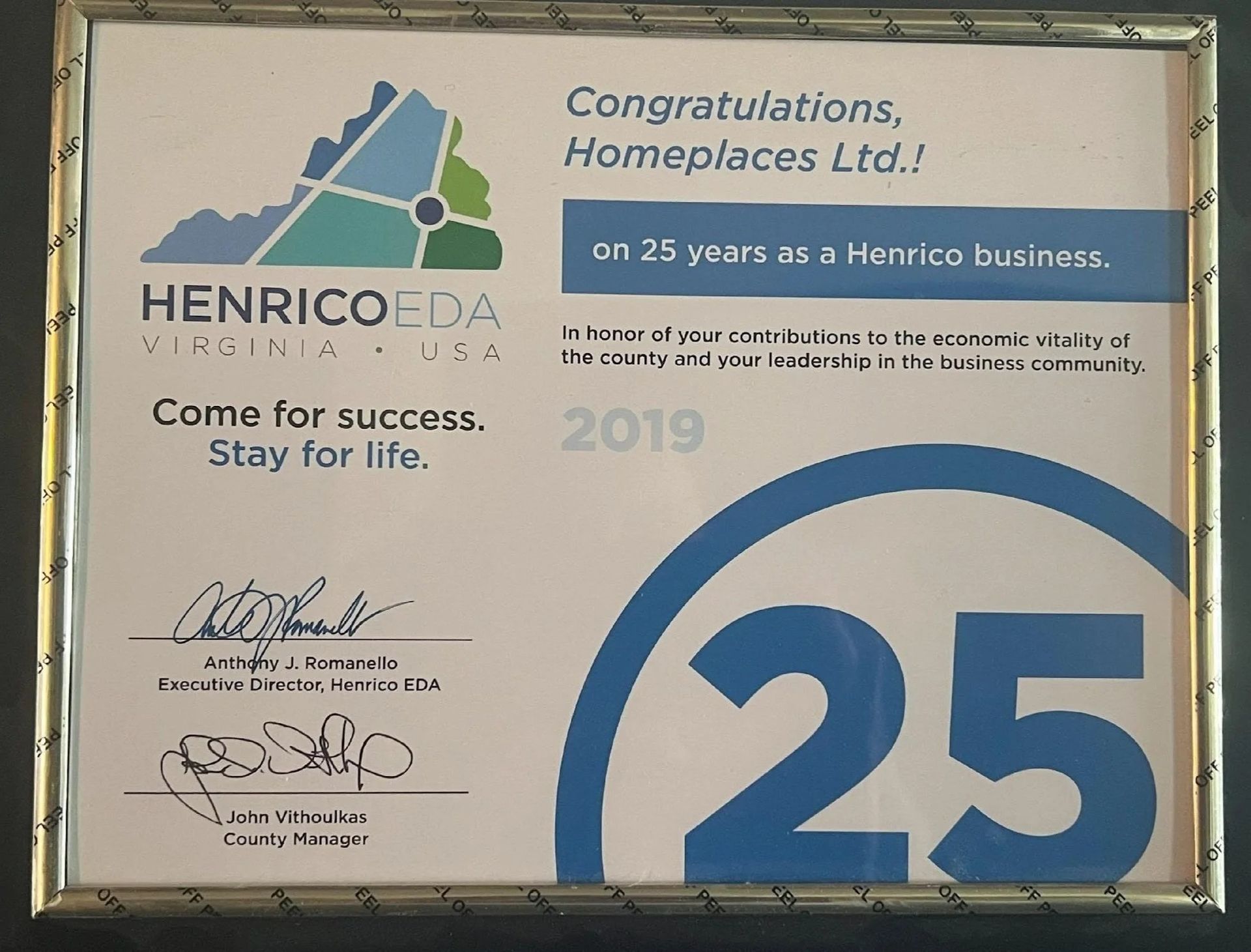 A 2019 Henrico EDA award plaque congratulating Homeplaces Ltd. on 25 years of business in Henrico, Virginia.
