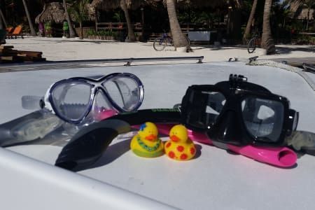 A couple of rubber ducks sitting on top of a boat