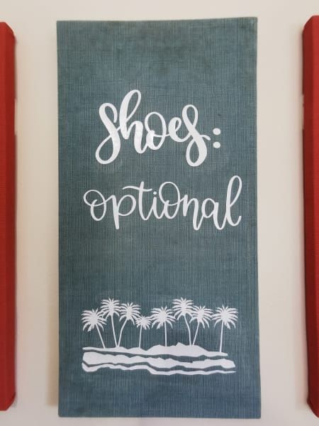 A sign on a wall that says shoes optional