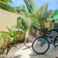 A couple of bicycles parked next to each other in a parking lot.