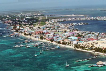An aerial view of a city surrounded by water and boats.
