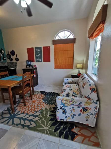 A living room with a couch , table and chairs
