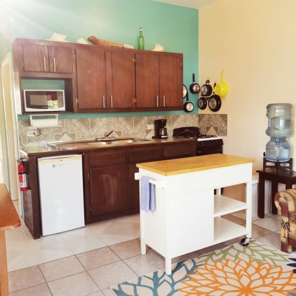 A kitchen with wooden cabinets and a white refrigerator