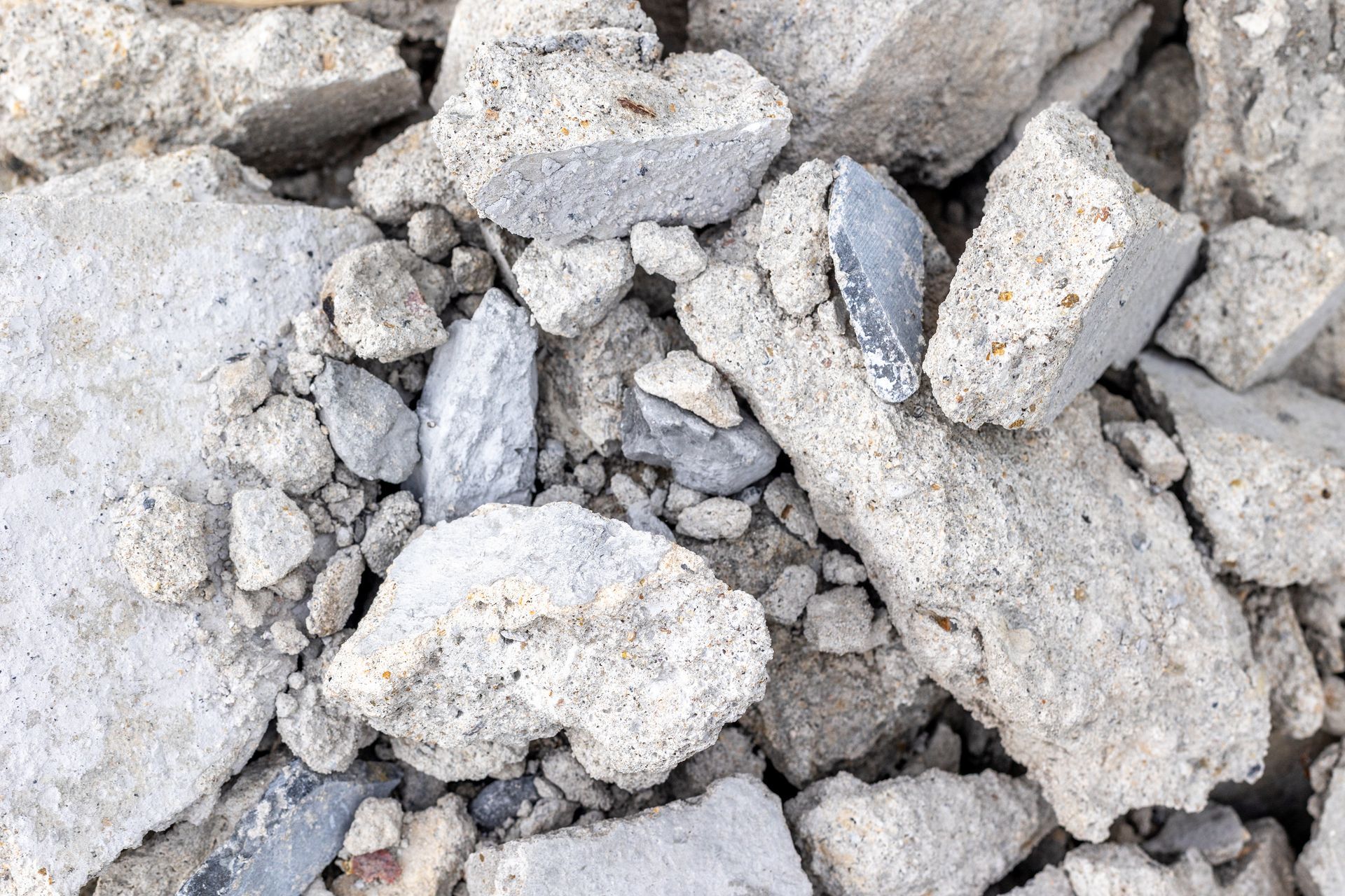 Close-up of crushed concrete rubble in a pile for recycling and construction material. Close-up of crushed concrete rubble in a pile for recycling and construction material.