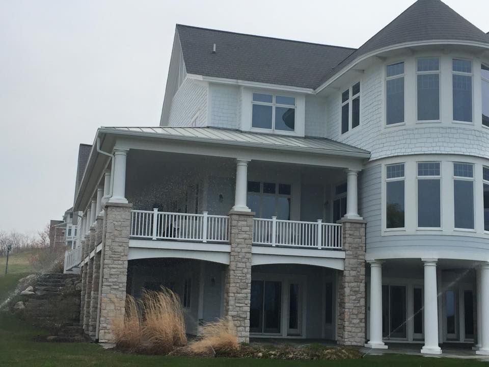 A large white house with a lot of windows and a porch