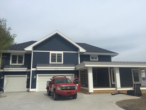 A wooden deck is being built underneath a house.
