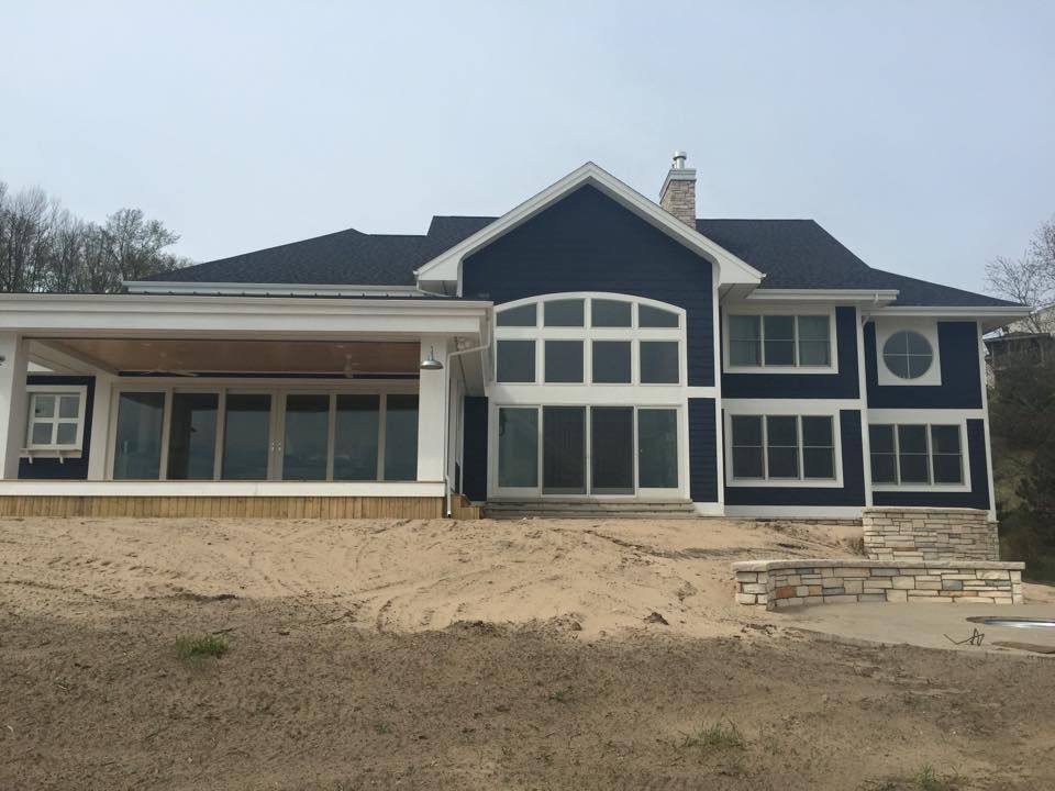 A large blue and white house with a lot of windows