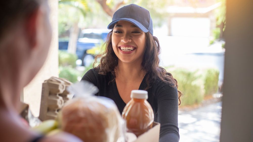 A woman is delivering groceries as a way to turn downtimes into paydays.