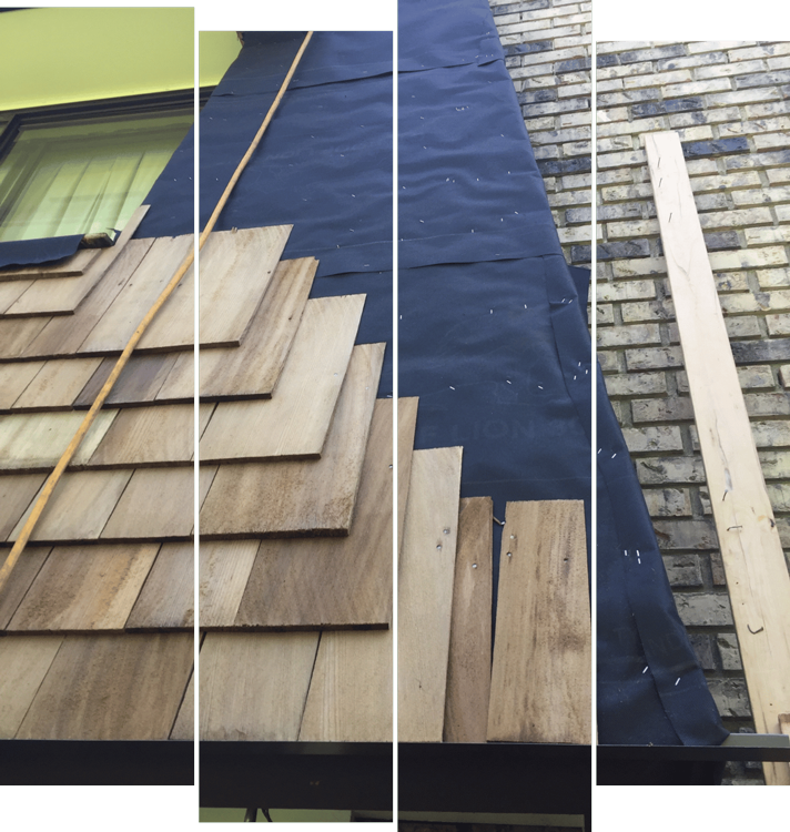 A wooden roof is being installed on a brick building