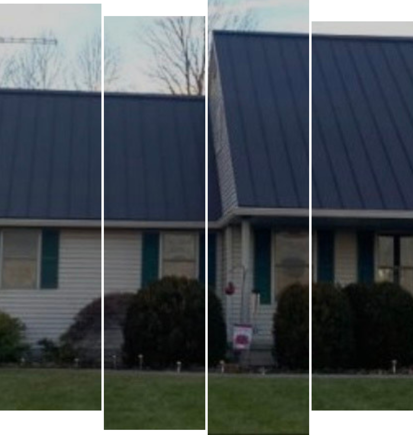 A white house with a blue roof and green shutters