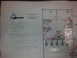 A floor plan of a building on a piece of paper.