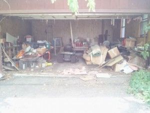 A garage filled with lots of trash and junk.