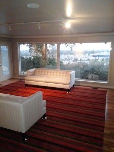 A living room with a couch , chairs , and a large window.