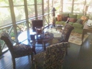 A living room with a table and chairs and a couch.