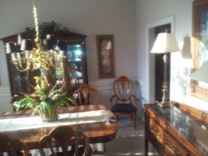 A dining room with a table and chairs and a chandelier