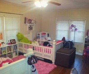 A bedroom with two beds and a ceiling fan.