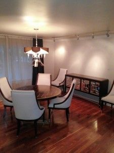 A dining room with a table and chairs and a chandelier.