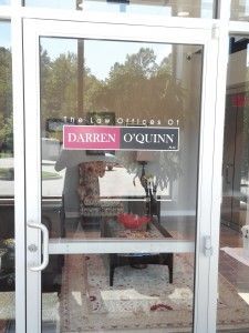 A glass door with a sign on it that says darren o ' quinn