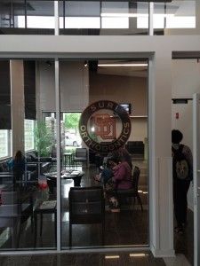 A group of people are sitting in a waiting room in a building.
