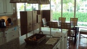 A kitchen with a large island and a dining room in the background.