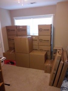 A room filled with lots of cardboard boxes and a window.