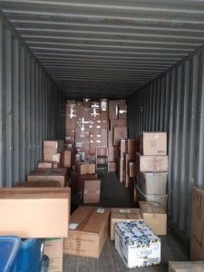 A shipping container filled with lots of cardboard boxes.