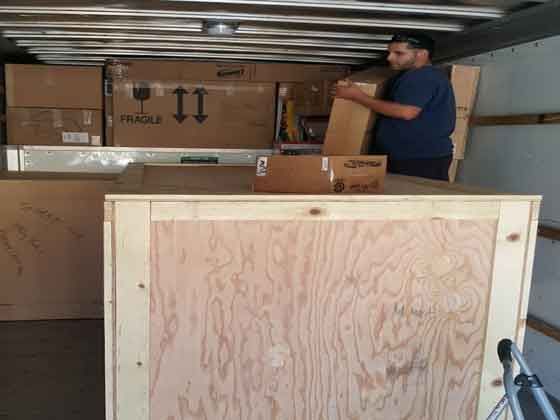 A man is loading boxes into a truck.