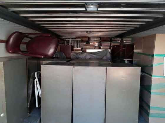 A truck filled with lots of furniture and boxes.
