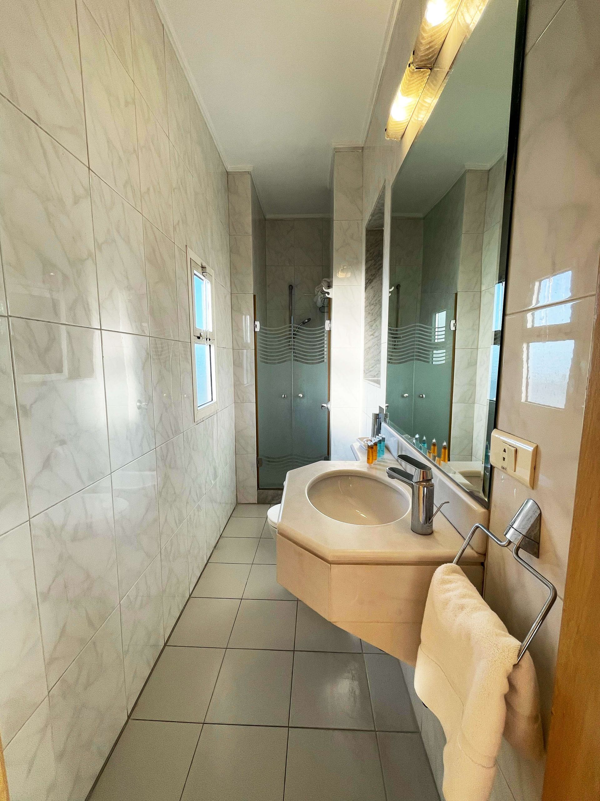 A bathroom with a sink and a towel rack