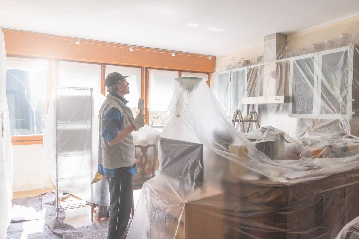 Painter in a home with drop cloths for protection near Bourbonnais, Illinois (IL)