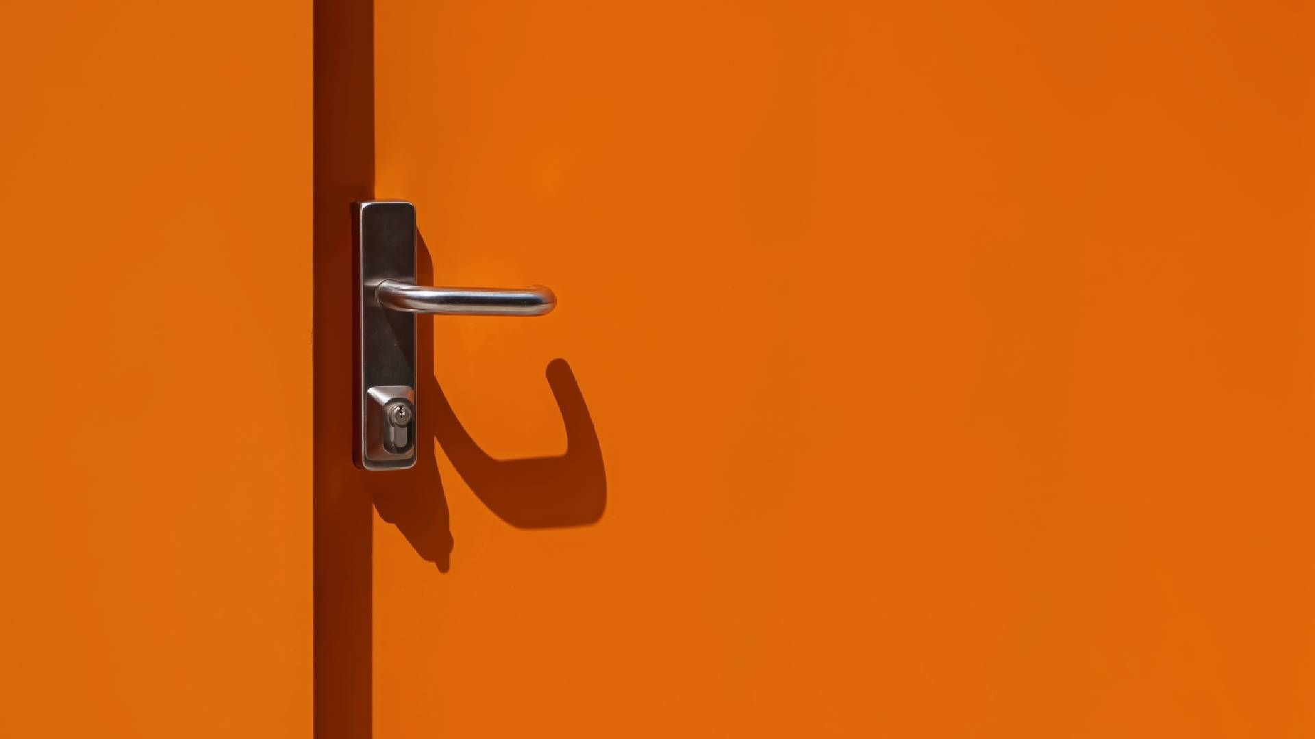 Orange metal door with a fresh coat of paint near Bourbonnais, Illinois (IL)