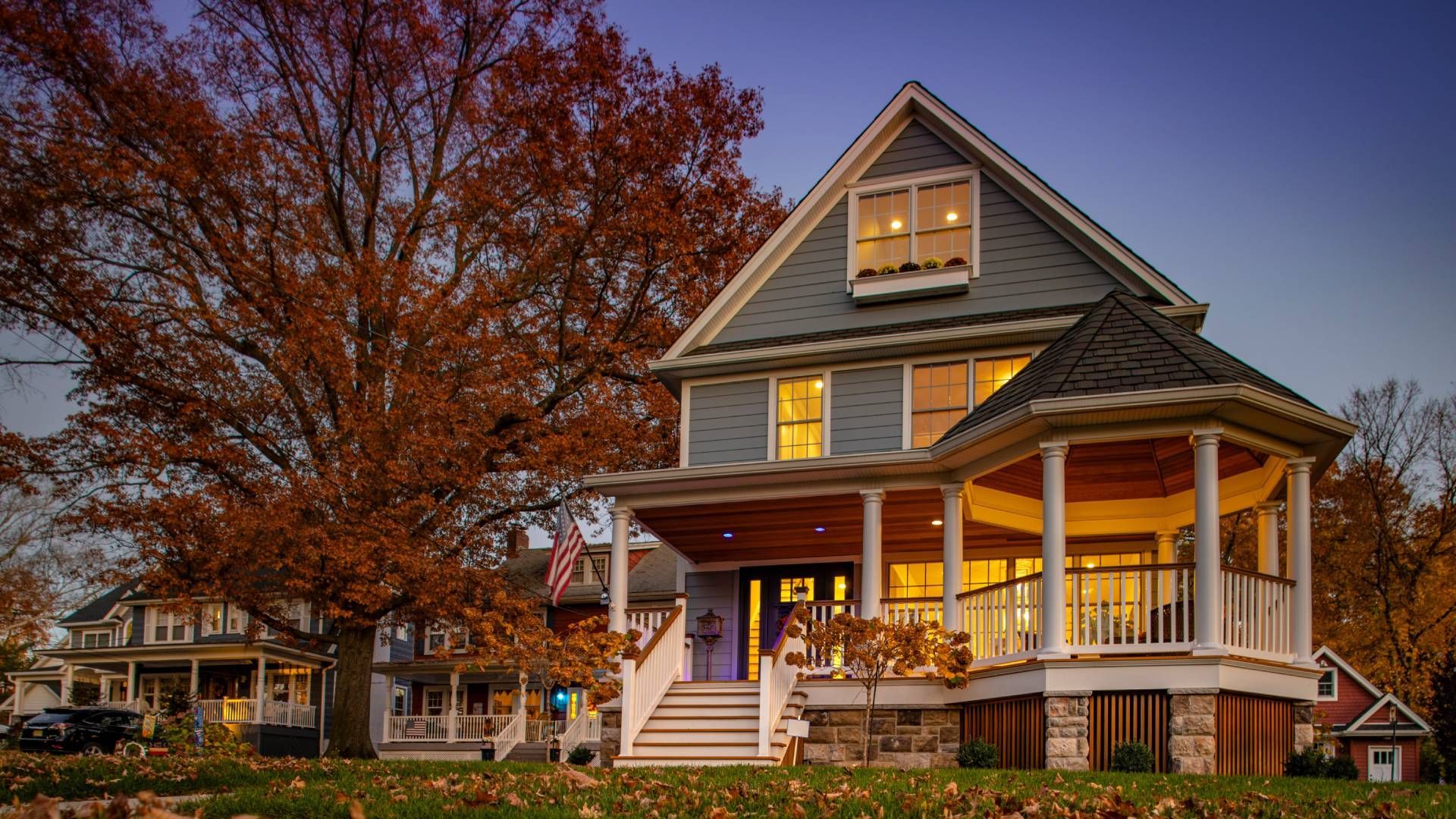 A home with a clear sky and an Autumn-colored tree at John Paul's Paint & Decor near Bourbonnais, Il