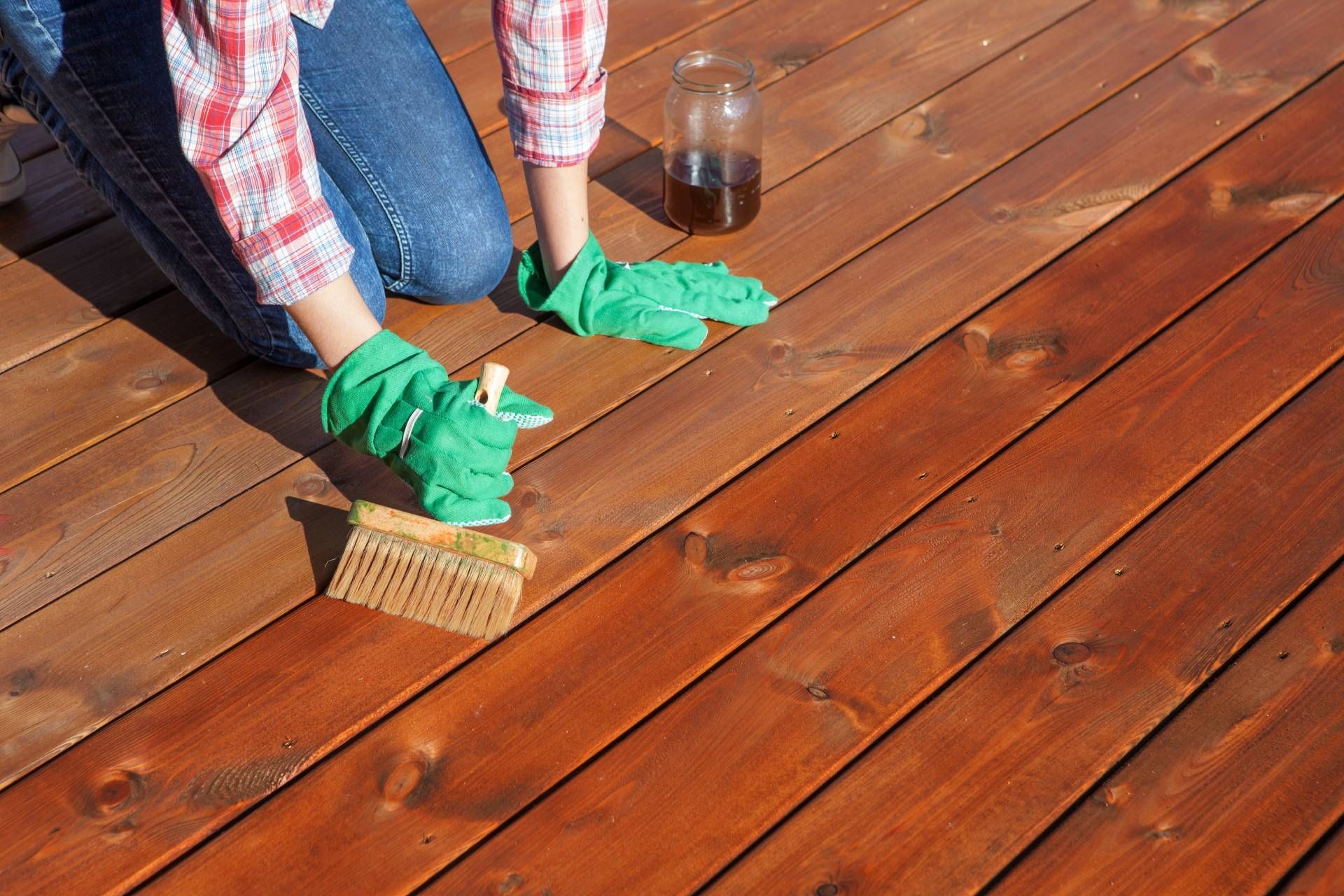 Someone applying a wood stain and finish to a deck near Bourbonnais, Illinois (IL)