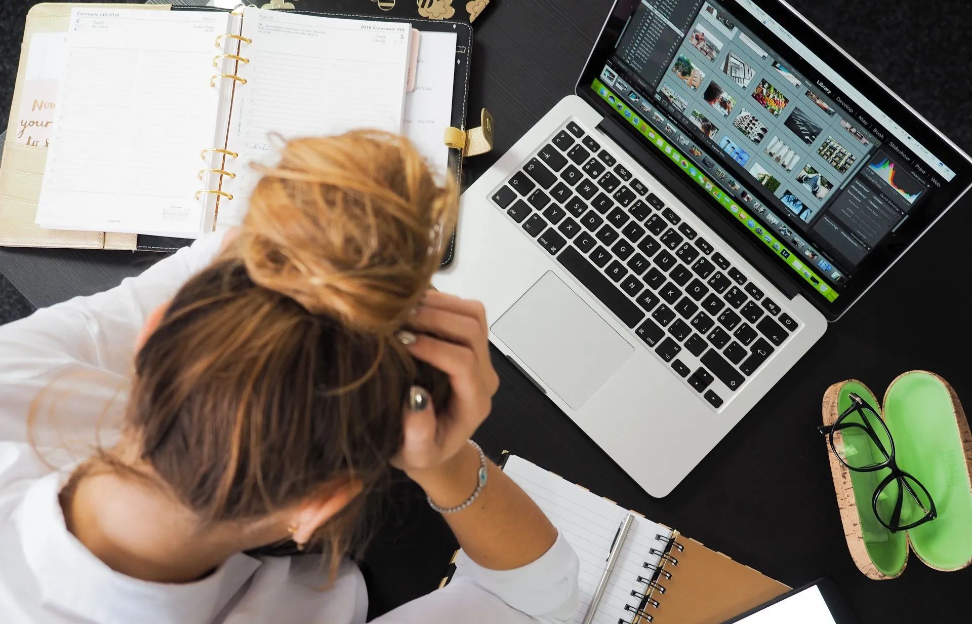 Girl with hands on head in frustration while designing a website