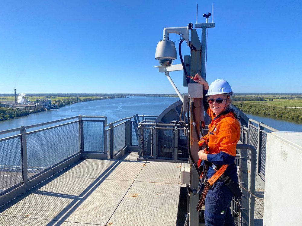 Woman in Safety Gear on A Tower Adjusting a Camera  — McGrath Electrical & Data in South Grafton, NS